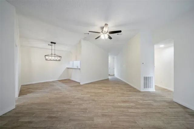 a view of empty room with ceiling fan