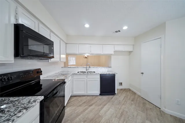 a kitchen with stainless steel appliances granite countertop a stove top oven and sink