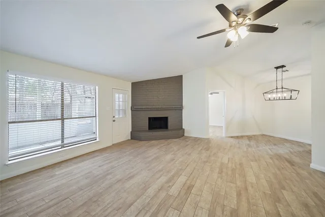 an empty room with fan and windows