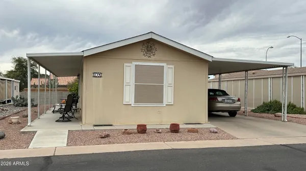 a front view of a house with cars