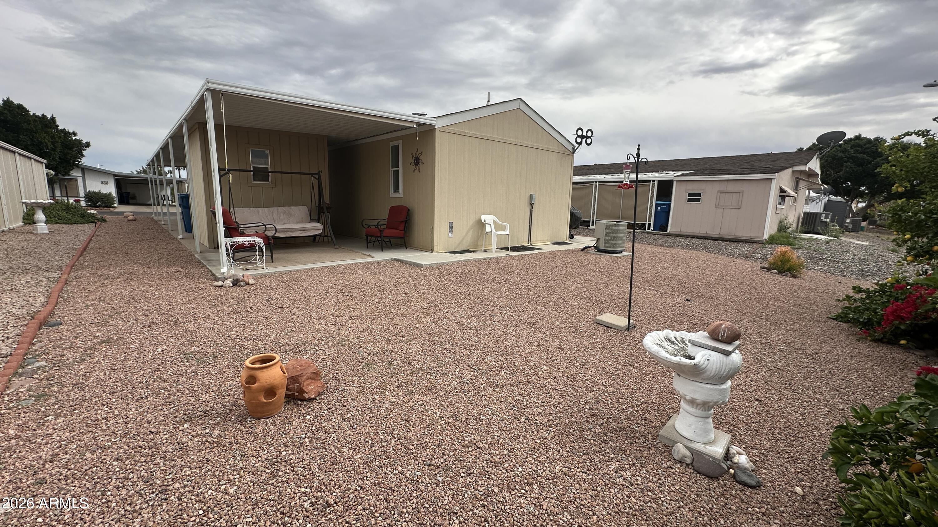 834 South Meridian Road, Unit 174 Apache Junction, AZ 85120 - Photo 19 of 56 a view of a house with backyard