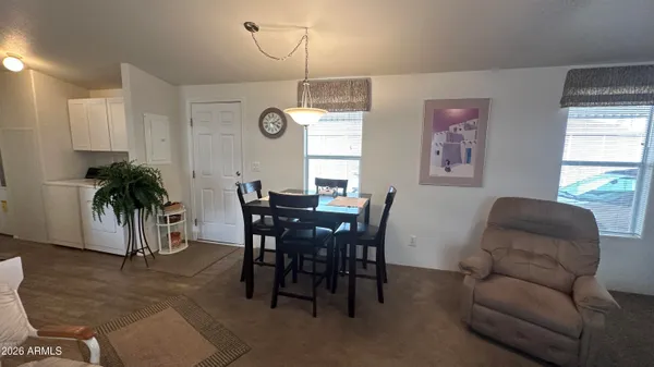 a living room with furniture a large window and chairs