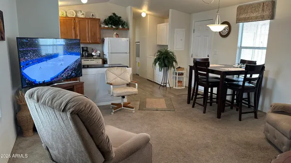 a living room with furniture potted plant and a chandelier