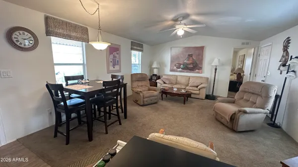 a view of a dining room with furniture and a large window