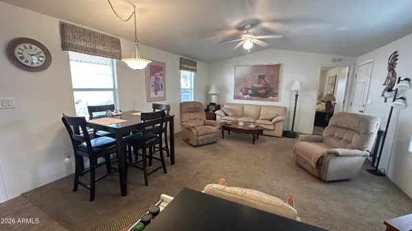 a view of a dining room with furniture and a window