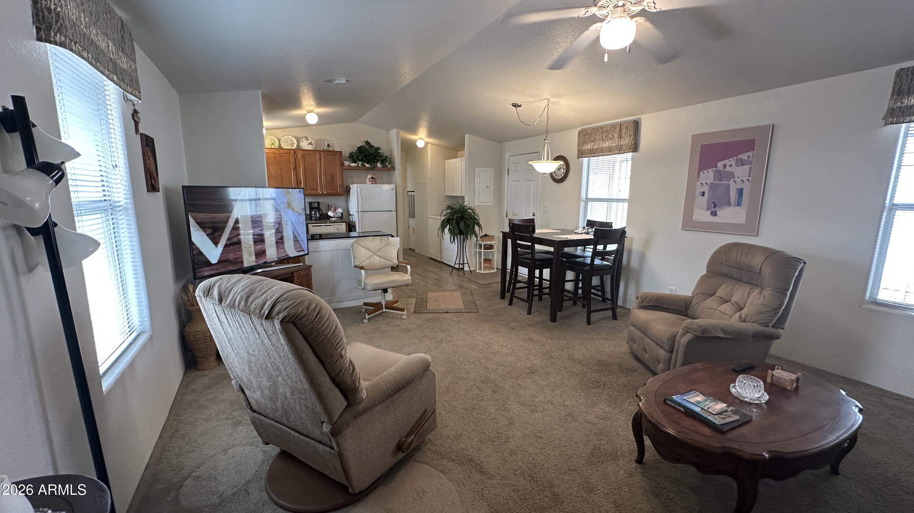 834 South Meridian Road, Unit 174 Apache Junction, AZ 85120 - Photo 34 of 56 a living room with furniture potted plant and a chandelier