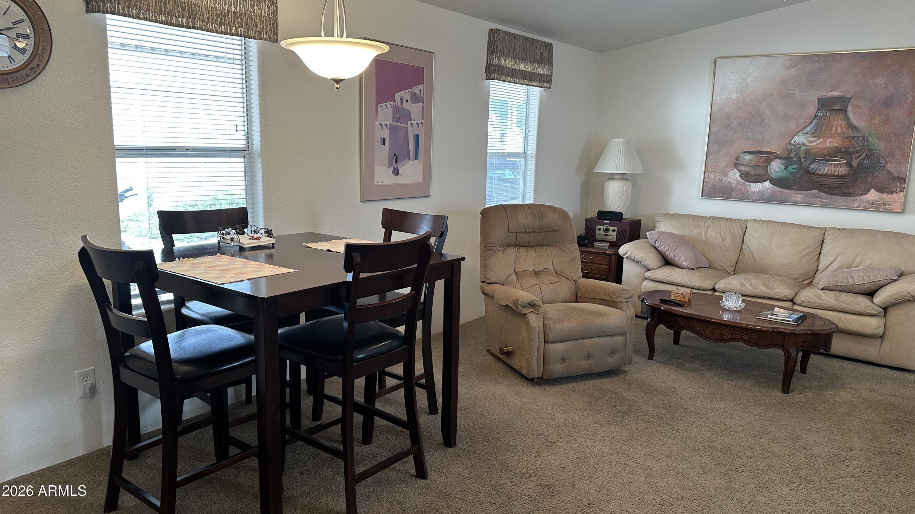 834 South Meridian Road, Unit 174 Apache Junction, AZ 85120 - Photo 35 of 56 a view of a dining room with furniture and a large window