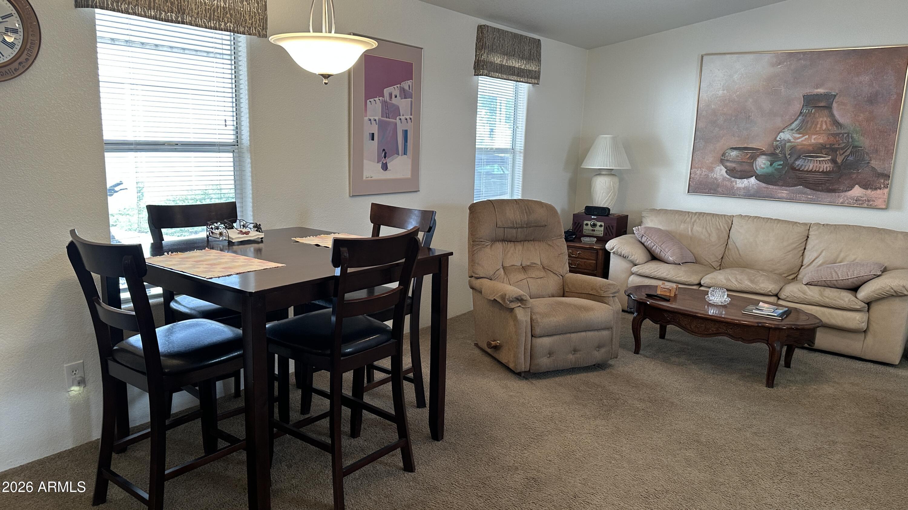 834 South Meridian Road, Unit 174 Apache Junction, AZ 85120 - Photo 36 of 56 a view of a dining room with furniture and a window