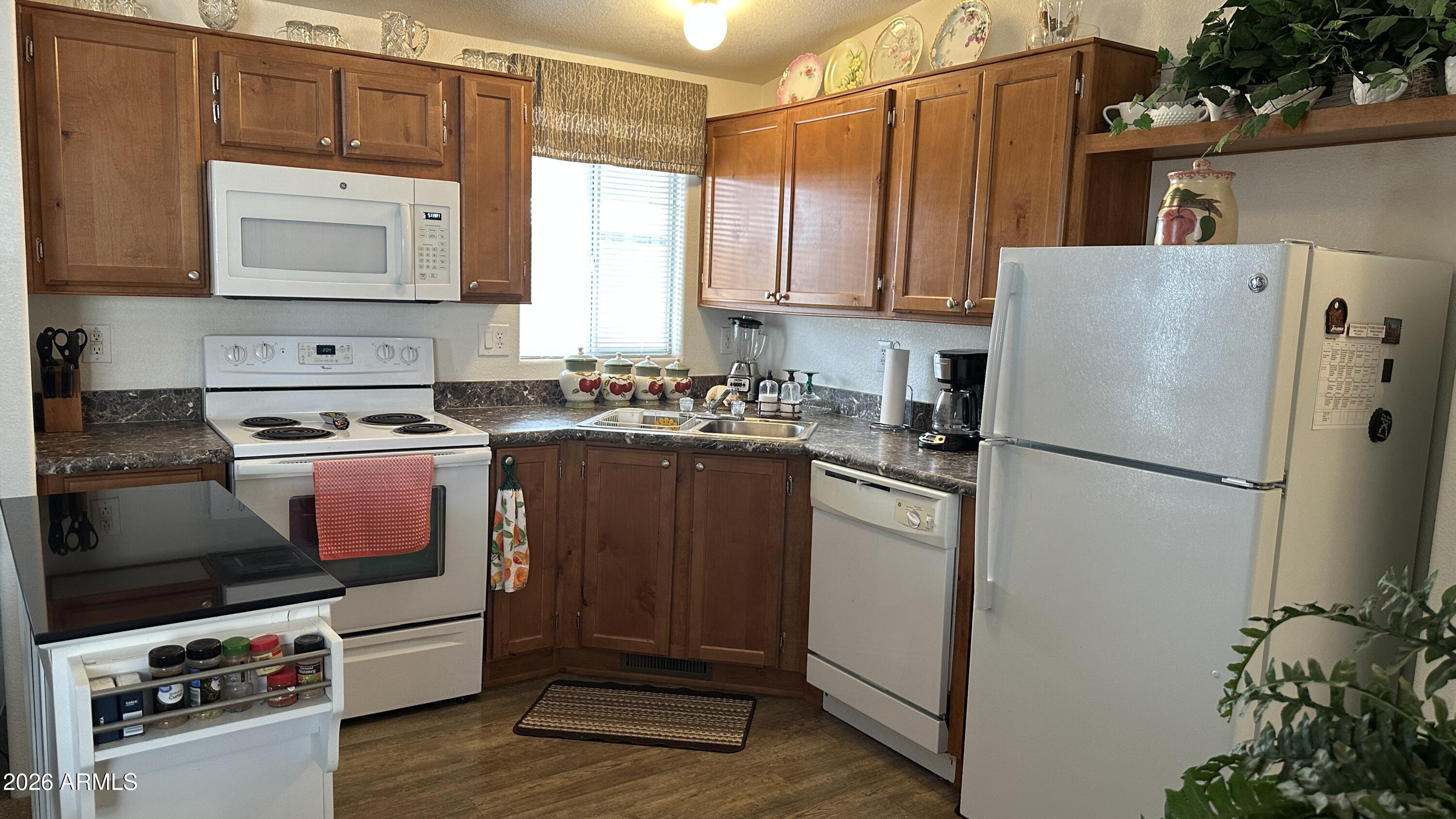834 South Meridian Road, Unit 174 Apache Junction, AZ 85120 - Photo 40 of 56 a kitchen with stainless steel appliances a refrigerator stove and sink
