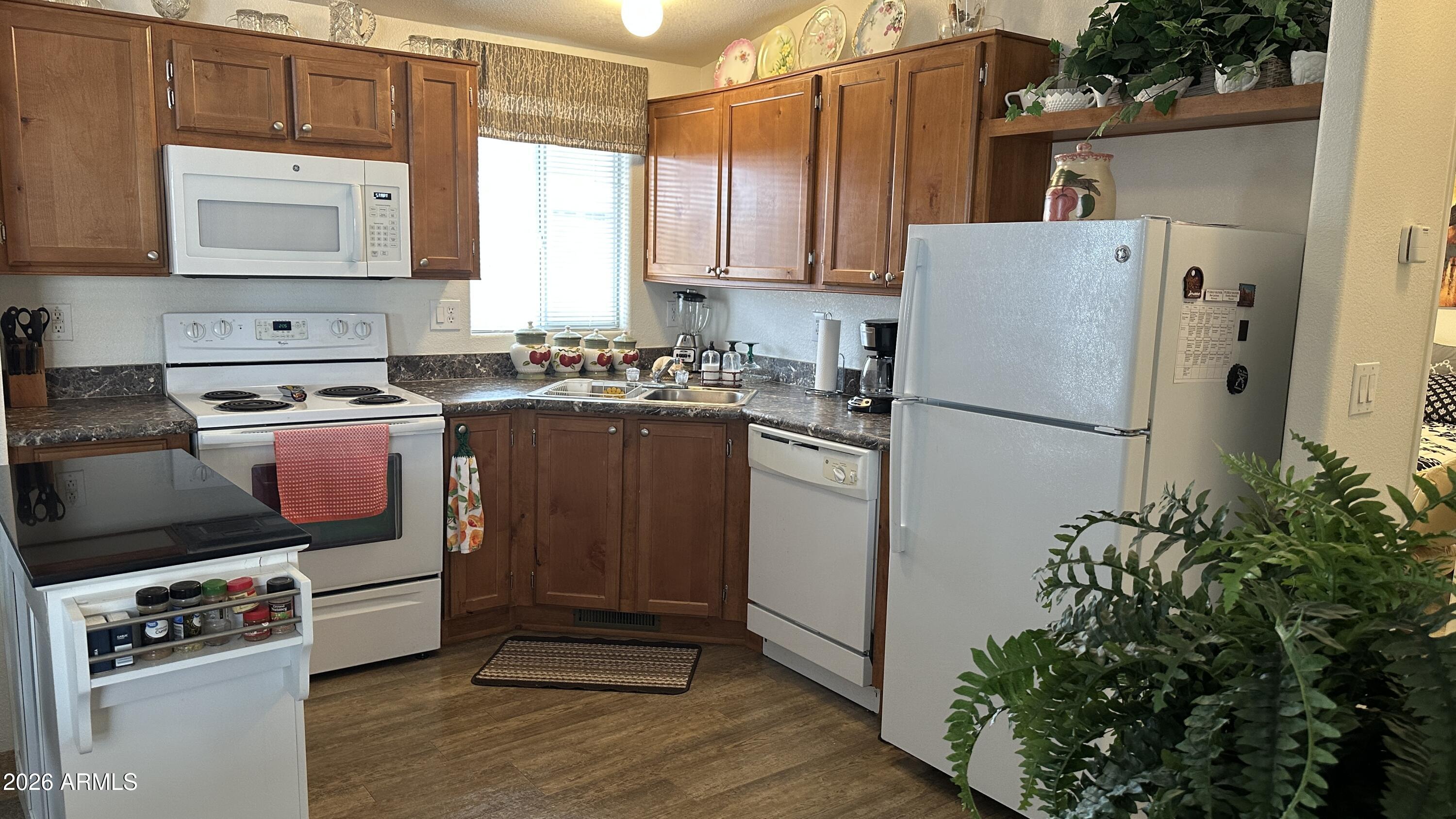 834 South Meridian Road, Unit 174 Apache Junction, AZ 85120 - Photo 41 of 56 a kitchen with stainless steel appliances granite countertop a refrigerator sink and stove