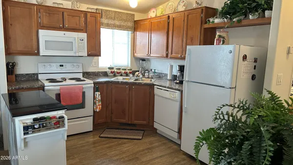 a bedroom with a bed and a closet with wooden floor