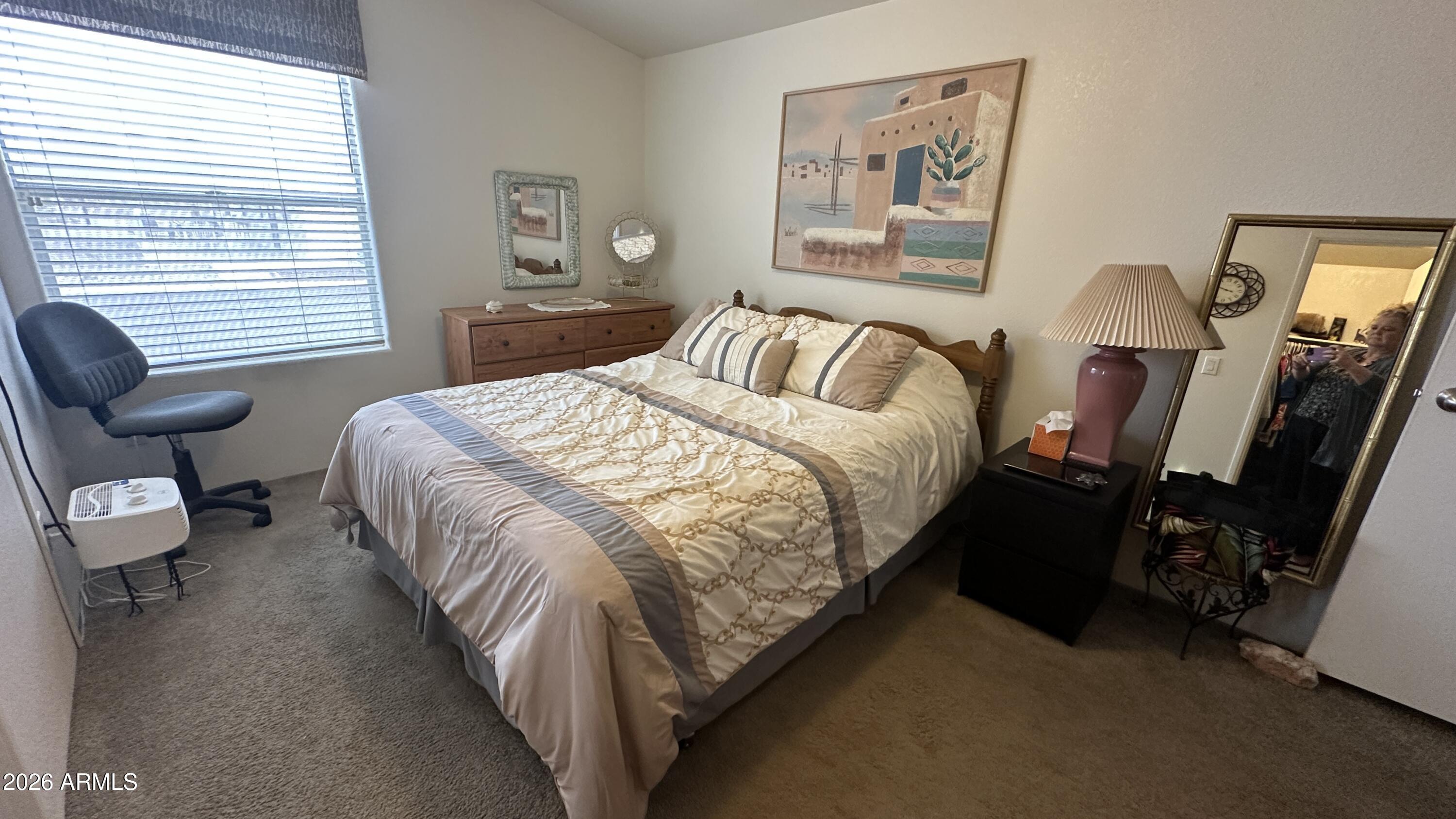 834 South Meridian Road, Unit 174 Apache Junction, AZ 85120 - Photo 49 of 56 a bed room with a bed and a chair