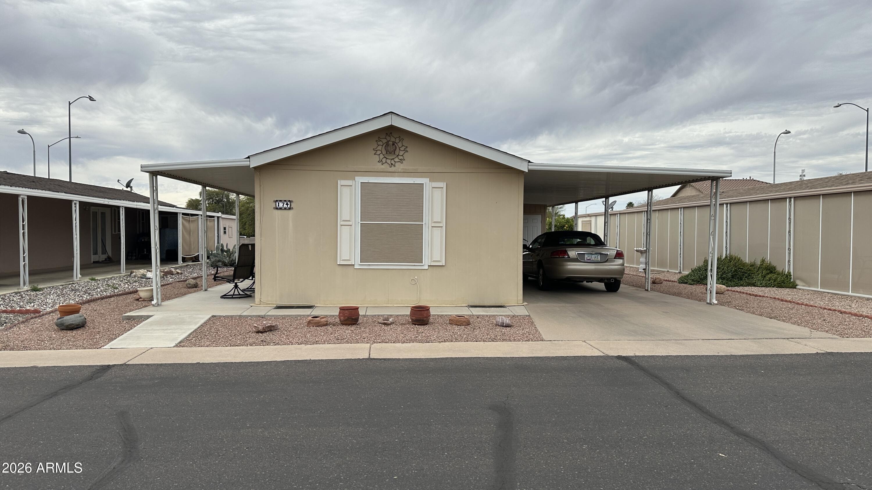 834 South Meridian Road, Unit 174 Apache Junction, AZ 85120 - Photo 5 of 56 a view of a house with car parked