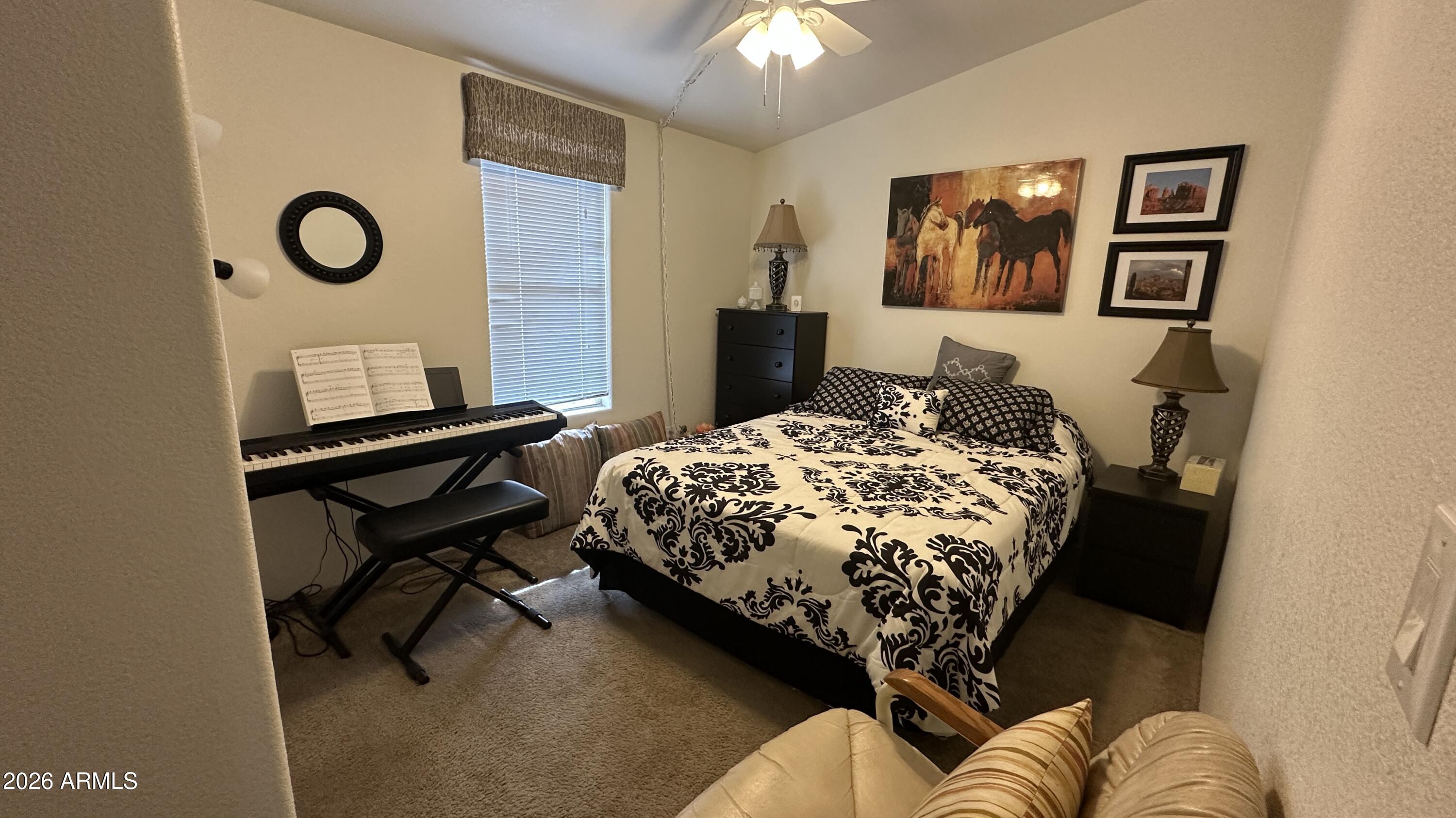 834 South Meridian Road, Unit 174 Apache Junction, AZ 85120 - Photo 53 of 56 a bed sitting in a bedroom next to a window with desk and chair