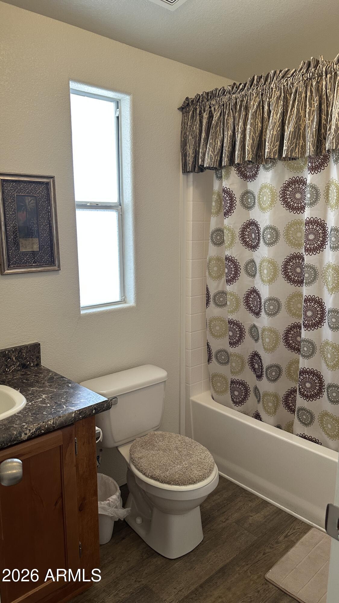 834 South Meridian Road, Unit 174 Apache Junction, AZ 85120 - Photo 56 of 56 a bathroom with a granite countertop toilet a sink and a mirror