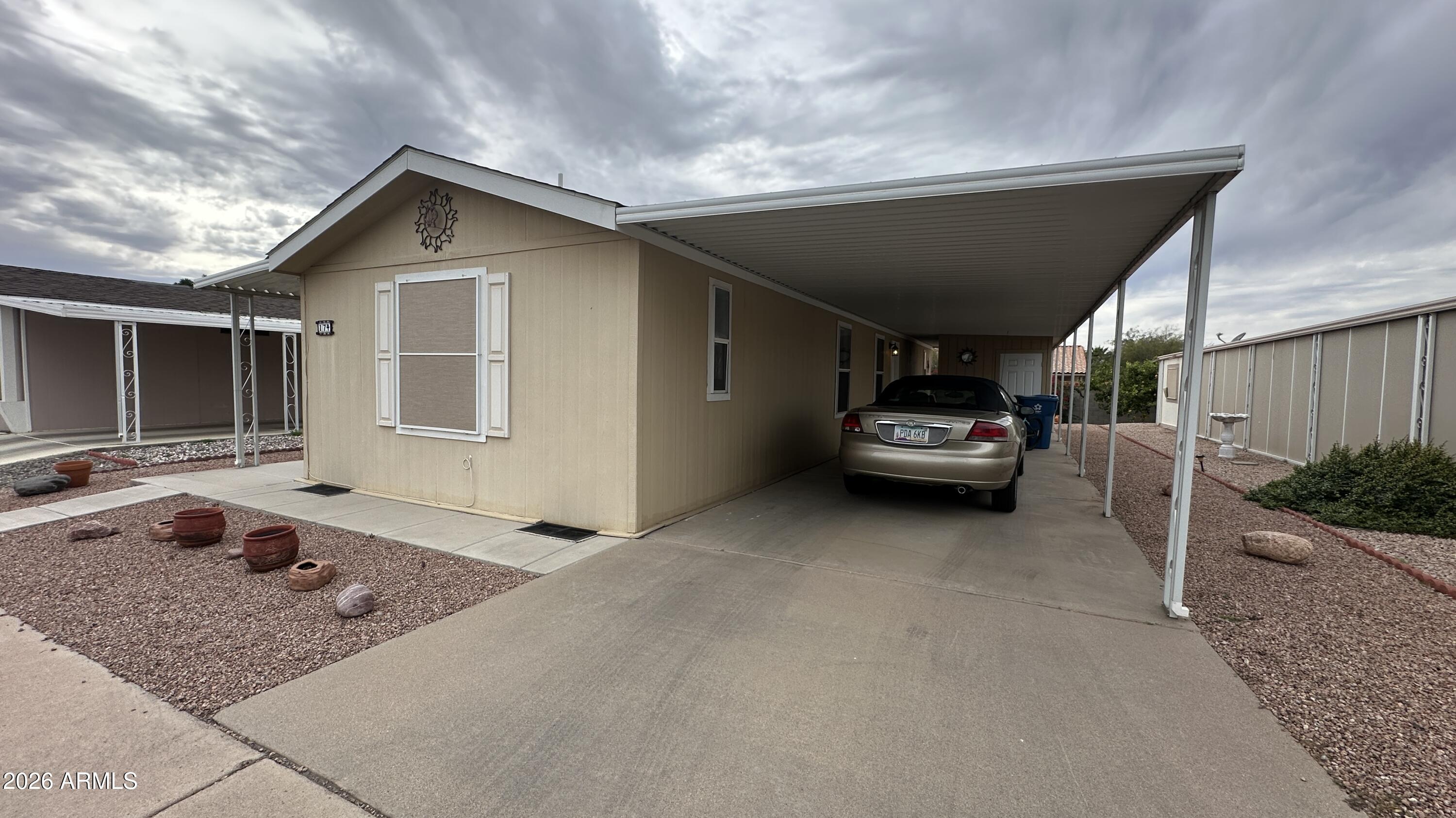 834 South Meridian Road, Unit 174 Apache Junction, AZ 85120 - Photo 6 of 56 a car parked in garage of a house