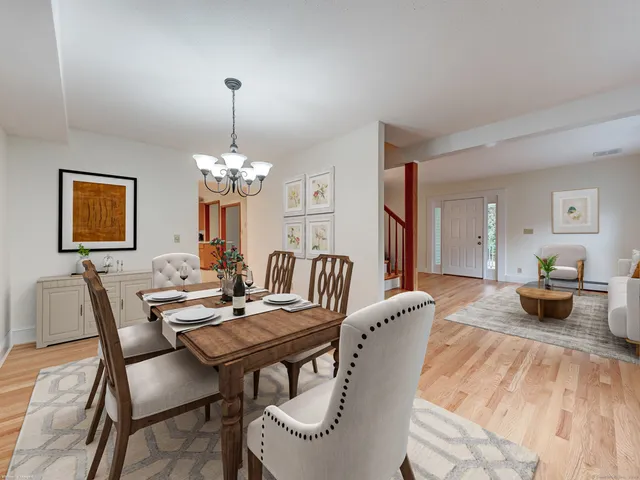 a view of a dining room with furniture and chandelier
