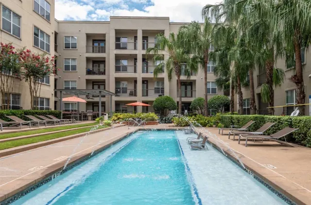 a front view of residential houses with yard and swimming pool