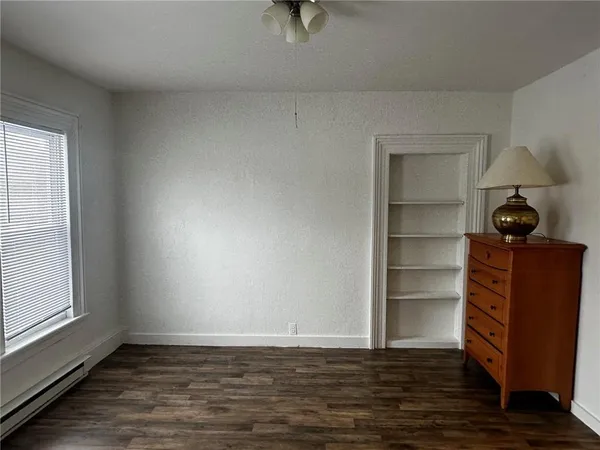 a view of a room with wooden floor and cabinet