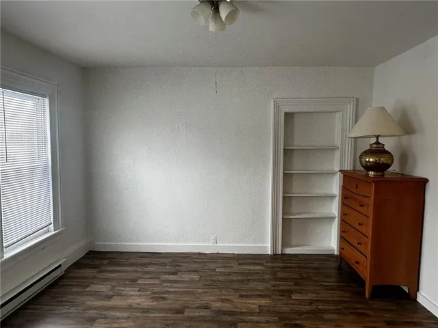 a view of a room with wooden floor and cabinet