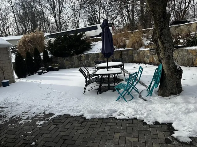 a backyard of a house with table and chairs