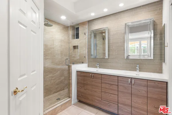 a bathroom with a granite countertop sink mirror and double