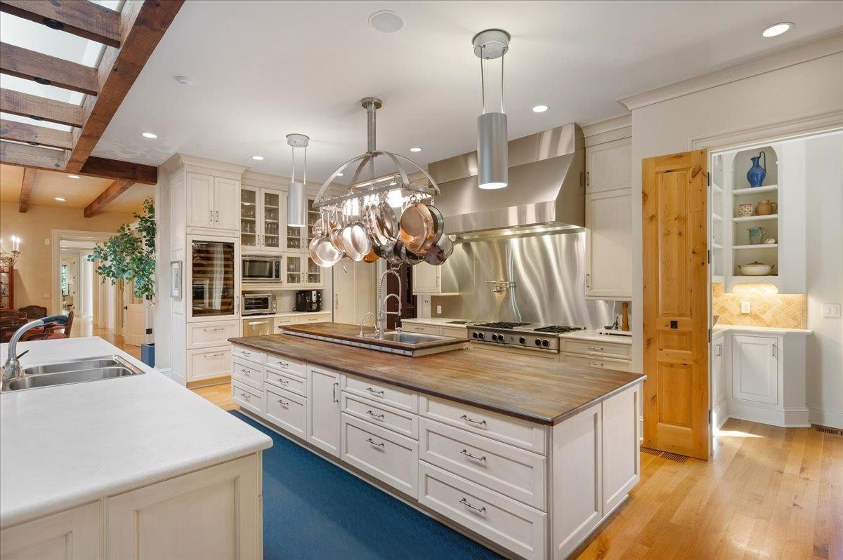 3300 Avon Road Durham, NC 27707 - Photo 18 of 67 a view of a kitchen with kitchen island a counter top space and stainless steel appliances