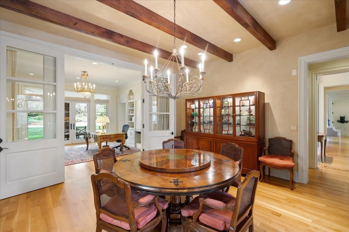 3300 Avon Road Durham, NC 27707 - Photo 21 of 67 a dining room with furniture a chandelier and wooden floor