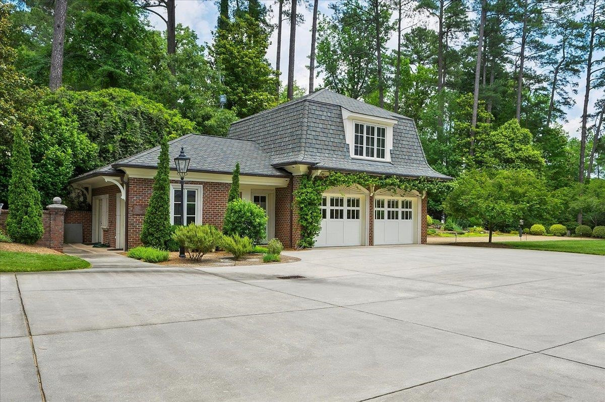 3300 Avon Road Durham, NC 27707 - Photo 52 of 67 a front view of a house with a yard and a garage