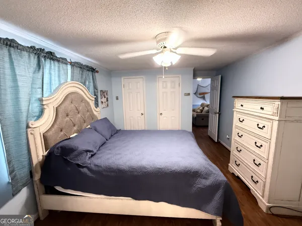a bedroom with a bed and a dresser