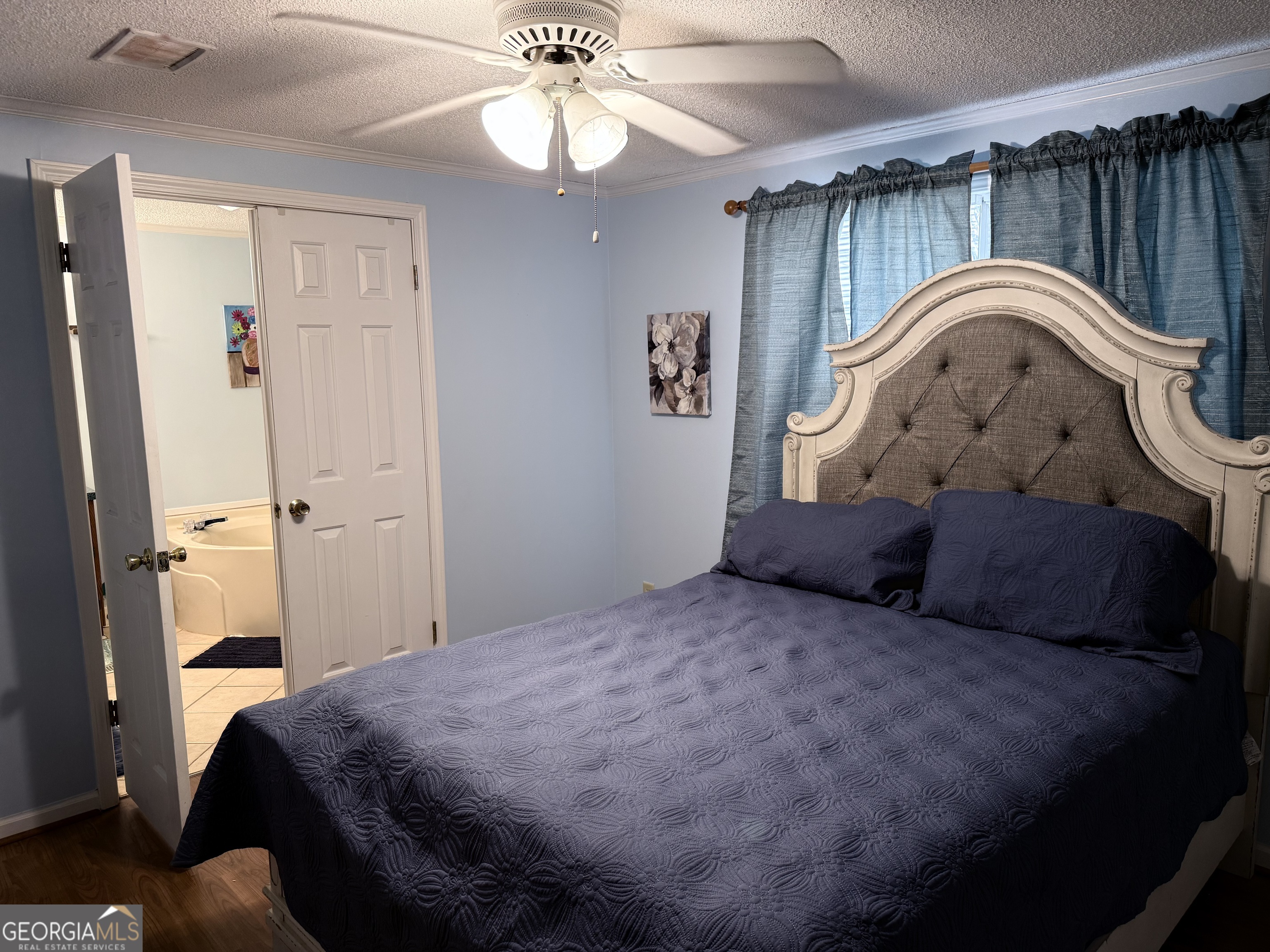 931 Shelor Ferry Road Fair Play, SC 29643 - Photo 12 of 26 a spacious bedroom with a bed and a chandelier