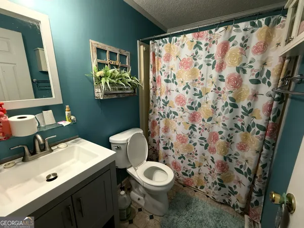 a bathroom with a toilet a sink and a mirror