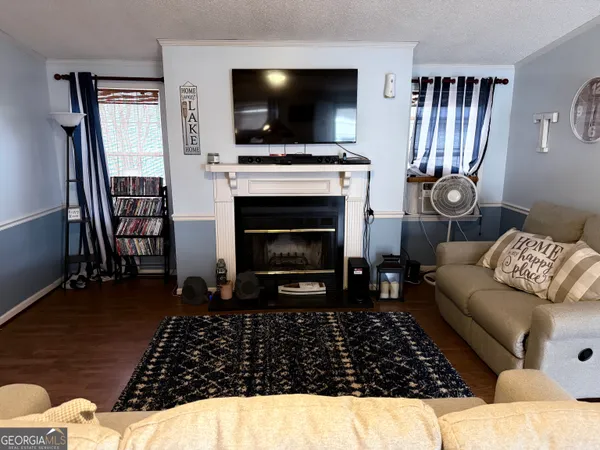a living room with furniture a flat screen tv and a fireplace