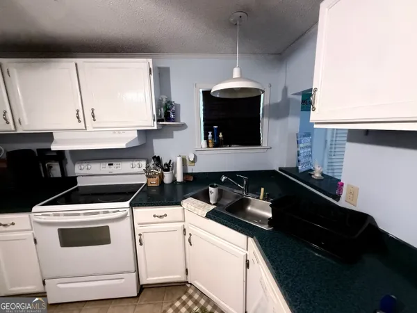 a kitchen with a stove and a microwave