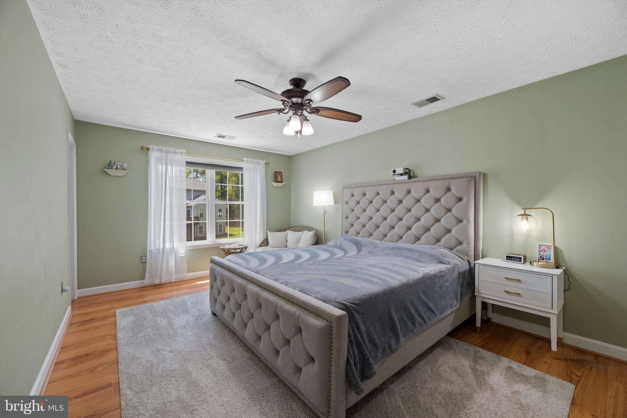 6330 Hanover Crossing Way Hanover, MD 21076 - Photo 12 of 32 a bedroom with a bed and a chandelier