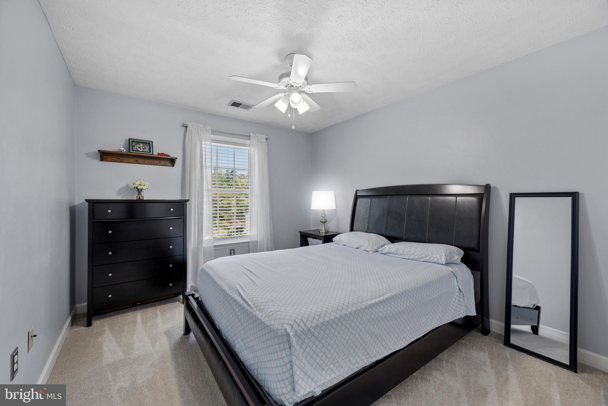 6330 Hanover Crossing Way Hanover, MD 21076 - Photo 15 of 32 a bedroom with a bed and a ceiling fan