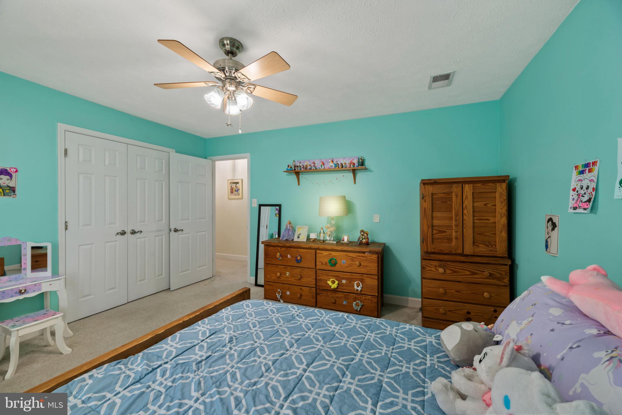 6330 Hanover Crossing Way Hanover, MD 21076 - Photo 17 of 32 a bedroom with a bed and a dresser in it
