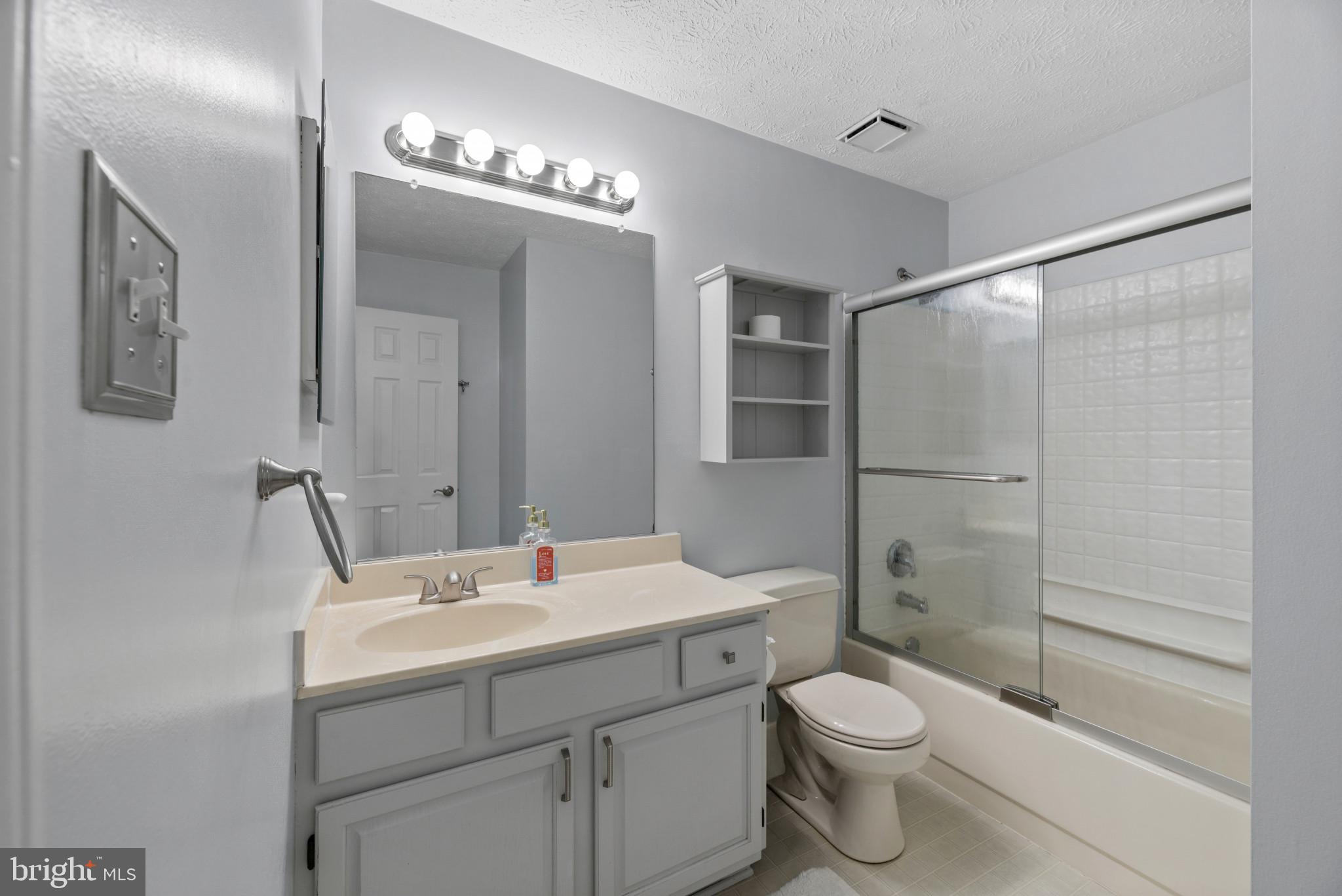 6330 Hanover Crossing Way Hanover, MD 21076 - Photo 18 of 32 a bathroom with a toilet sink shower and mirror