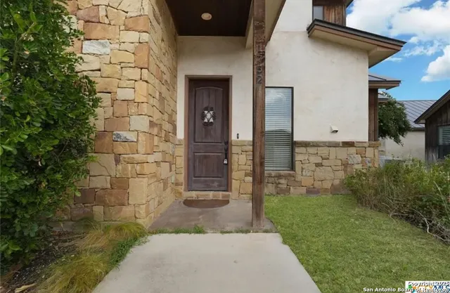 a view of a brick house with a yard