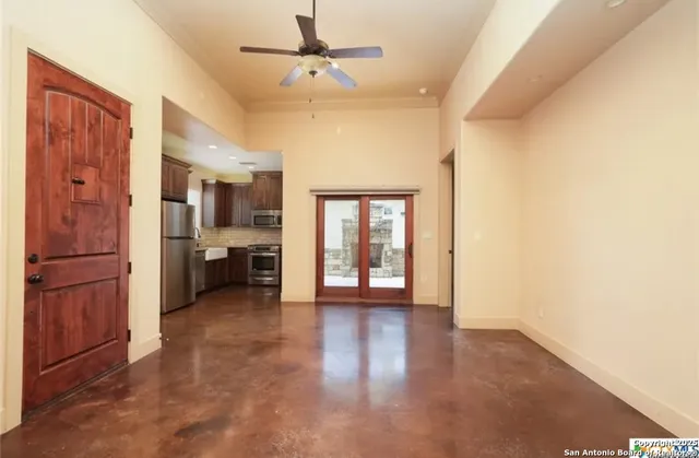 a view of a kitchen with a sink and a refrigerator