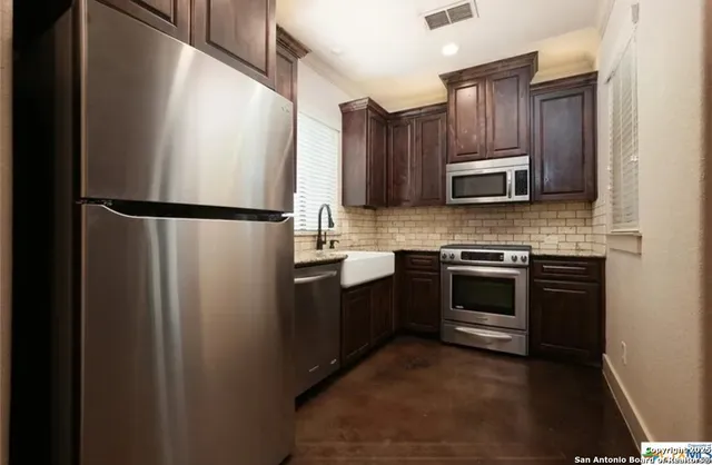 a kitchen with a refrigerator sink and microwave