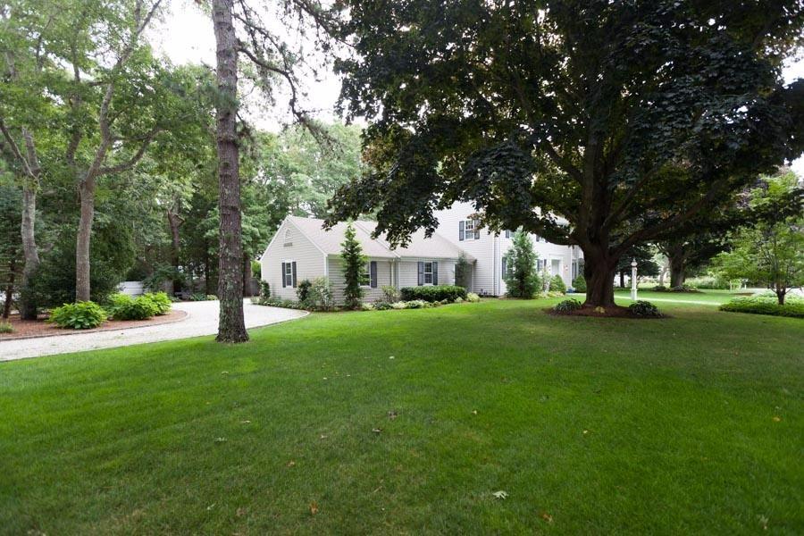 14 Bayview Road Osterville, MA 02655 - Photo 2 of 32 a view of a white house in front of a big yard with large trees