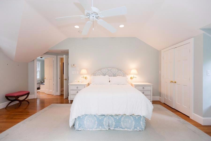 14 Bayview Road Osterville, MA 02655 - Photo 25 of 32 a spacious bedroom with a bed and a chandelier