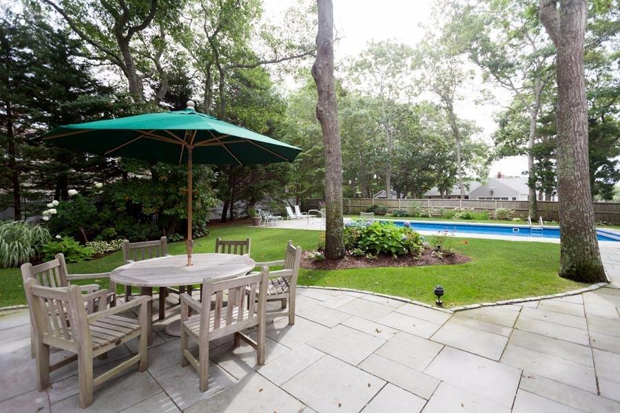 14 Bayview Road Osterville, MA 02655 - Photo 5 of 32 a view of a table and chairs under an umbrella