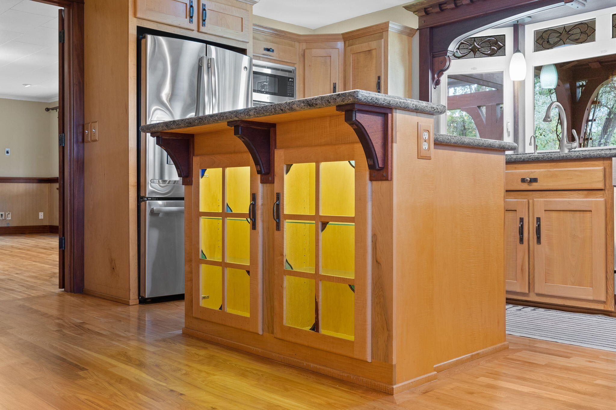21925 Bear Creek Road Bend, OR 97702 - Photo 24 of 104 Stained glass cabinet made of solid wood is lit on the island