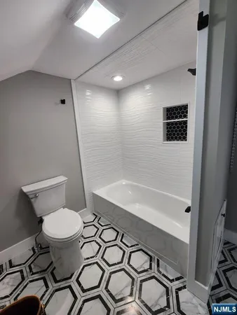 a bathroom with a sink a toilet and a shower