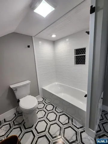 a bathroom with a sink a toilet and a shower