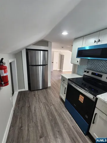 a kitchen with a stove and a refrigerator