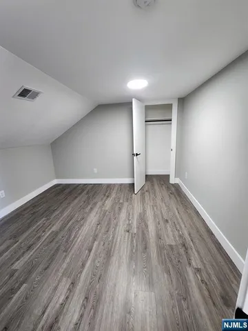 a view of wooden floor and windows in a room