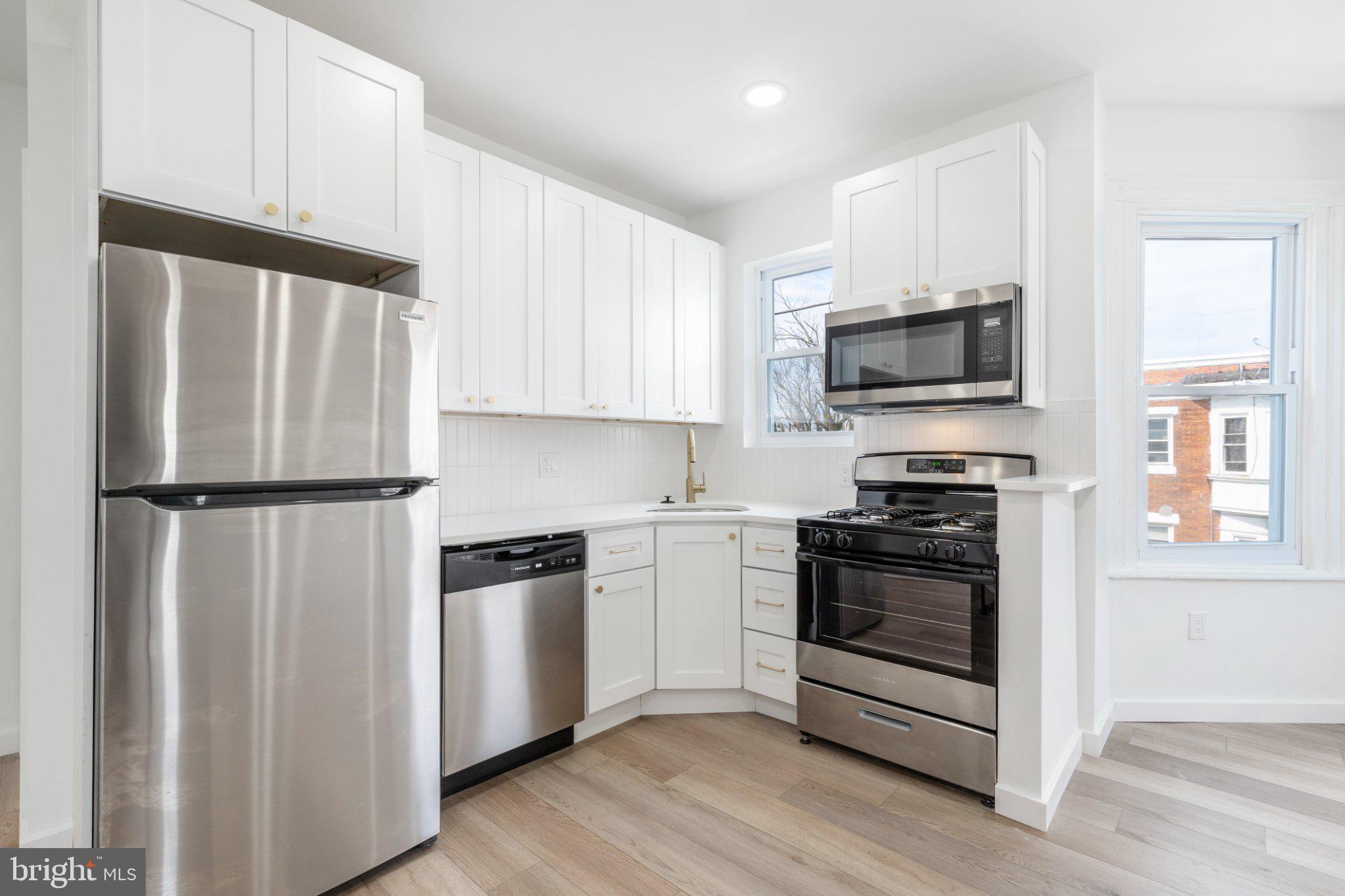5758 Spruce Street, Unit 2 Philadelphia, PA 19139 - Photo 8 of 25 Modern kitchen with sleek appliances.